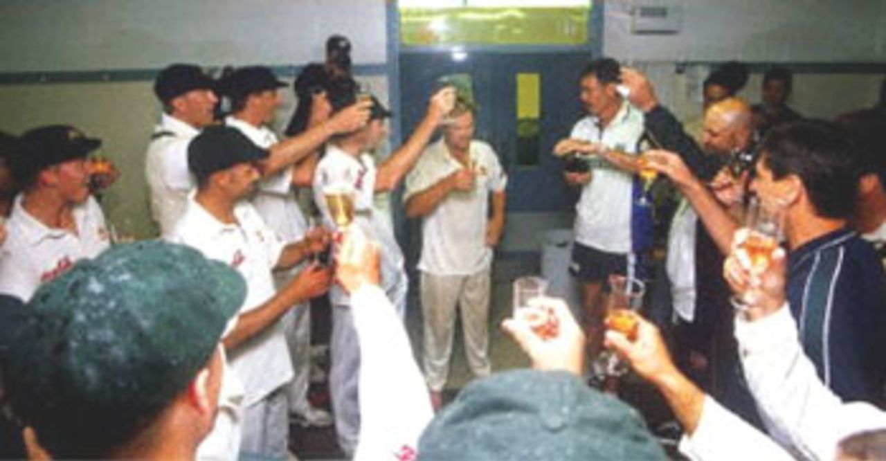 Australia spinner Shane Warne (C) is toasted by his team after taking the wicket of New Zealand batsman Paul Wiseman to break the Australian test wicke-taking record of 355 held by former paceman Dennis Lille on the last day of the first Test Match between Australia and New Zealand at Eden Park in Auckland 15 March 2000. Australia defeated New Zealand by 62 runs and in doing so also equalled the Australian record of eight consecutive test victories.