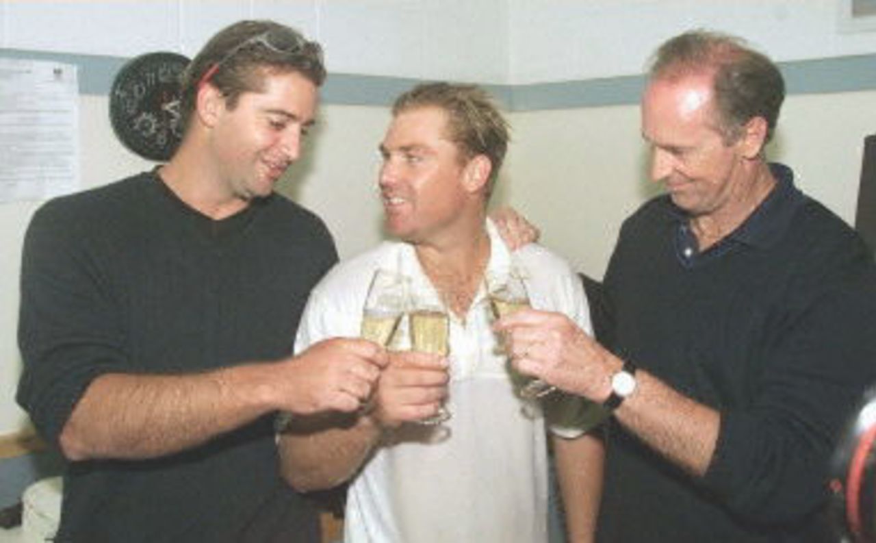 Australian spinner Shane Warne (C) is congratulated by his brother Jason (L) and father Keith (R) after Warne took the wicket of New Zealand batsman Paul Wiseman, his 356th career dismissal, to break the Australian Test wicket-taking record of 355 held by former paceman Dennis Lille, on the last day of the first Test match between Australia and New Zealand at Eden Park in Auckland 15 March 2000. Australia defeated New Zealand by 62 runs and in doing so also equalled the Australian record for consecutive Test victories at eight.