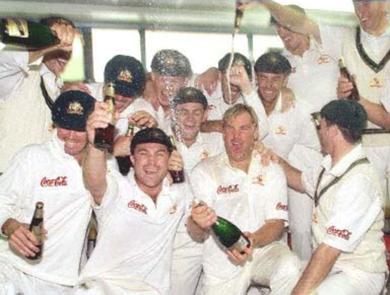 Australian spinner Shane Warne (C) sprays champagne as he and the teammates celebrate after Warne took the wicket of New Zealand batsman Paul Wiseman, the 356th of his career, to break the Australian Test wicket-taking record of 355 held by former paceman Dennis Lille, on the last day of the first Test match between Australia and New Zealand at Eden Park in Auckland 15 March 2000. Australia defeated New Zealand by 62 runs and in doing so also equalled the Australian record for consecutive Test victories at eight.