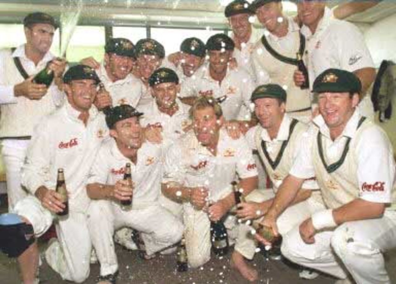 Australian spinner Shane Warne (front C) is sprayed with champagne as he and the teammates celebrate after Warne took the wicket of New Zealand batsman Paul Wiseman, his 356th career dismissal, to break the Australian Test wicket-taking record of 355 held by former paceman Dennis Lille, on the last day of the first Test match between Australia and New Zealand at Eden Park in Auckland 15 March 2000. Australia defeated New Zealand by 62 runs and in doing so also equalled the Australian record for consecutive Test victories at eight.