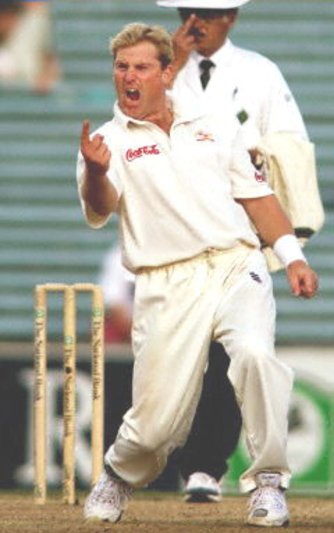 Australian spinner Shane Warne celebrates dismissing New Zealand batsman Nathan Astle to equal the Australian test wicket taking record held by former paceman Dennis Lillee on the third day of the first Test Match being played at Eden Park in Auckland, 13 March 2000. New Zealand who is chasing 281 runs for victory are 151-5 at stumps.