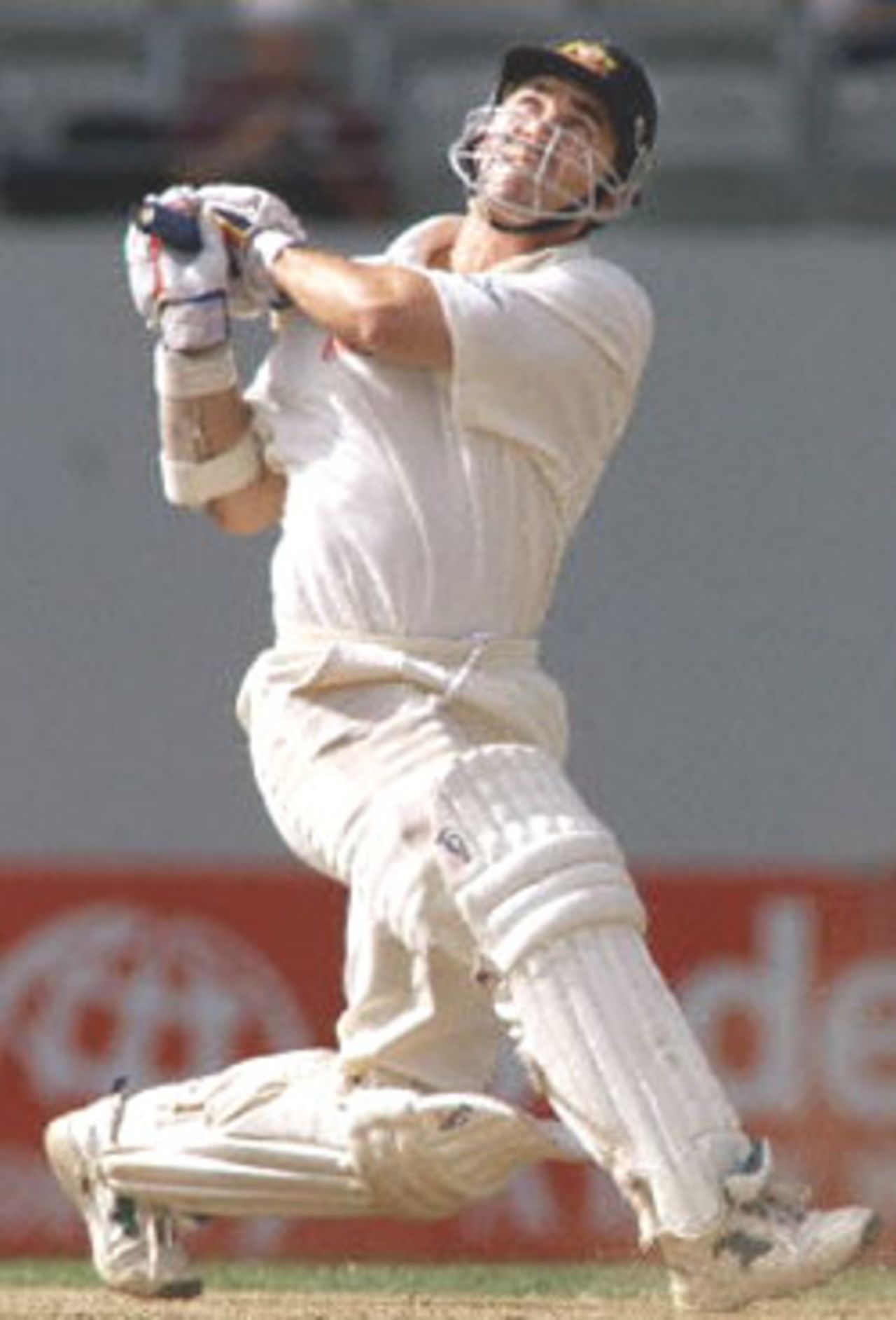 Australian batsman Justin Langer skies a ball to the outfield to be caught off the bowling of New Zealand's Daniel Vettori on the second day of the first Test match played at Eden Park in Auckland 12 March 2000. Australia dismissed New Zealand for 163 in their first innings and Australia in their second innings is 114-5 for a lead of 165 runs at stumps.