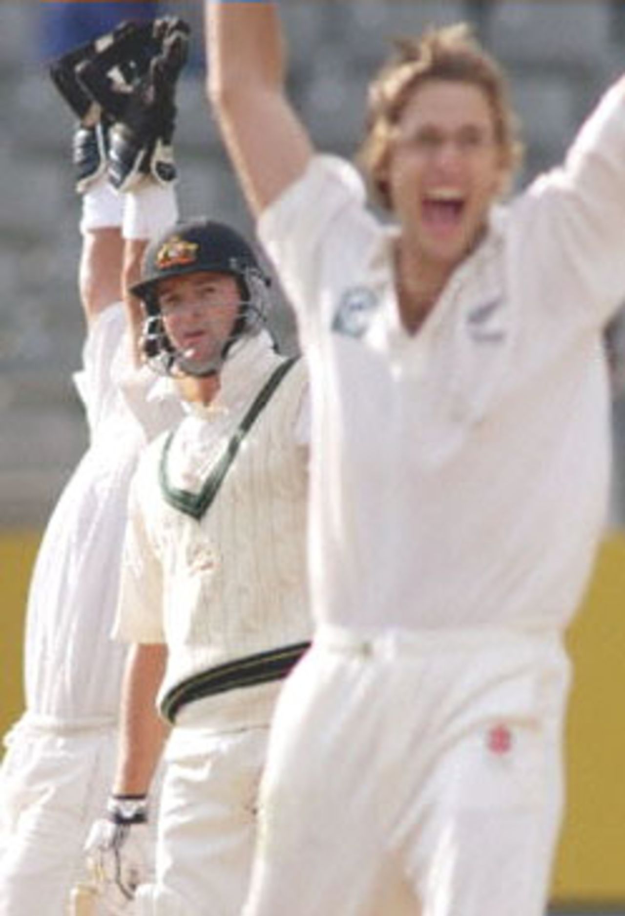Australian batsman Mark Waugh (C) looks back down the pitch to see that he is out-caught behind to the delight of New Zealand bowler Daniel Vettori (R) and wicketkeeper Adam Parore (L) on the second day of the first Test Match being played at Eden Park in Auckland, 12 March 2000. Australia dismissed New Zealand for 163 in their first innings and Australia in their second innings is 114-5 for a lead of 165 runs at stumps.
