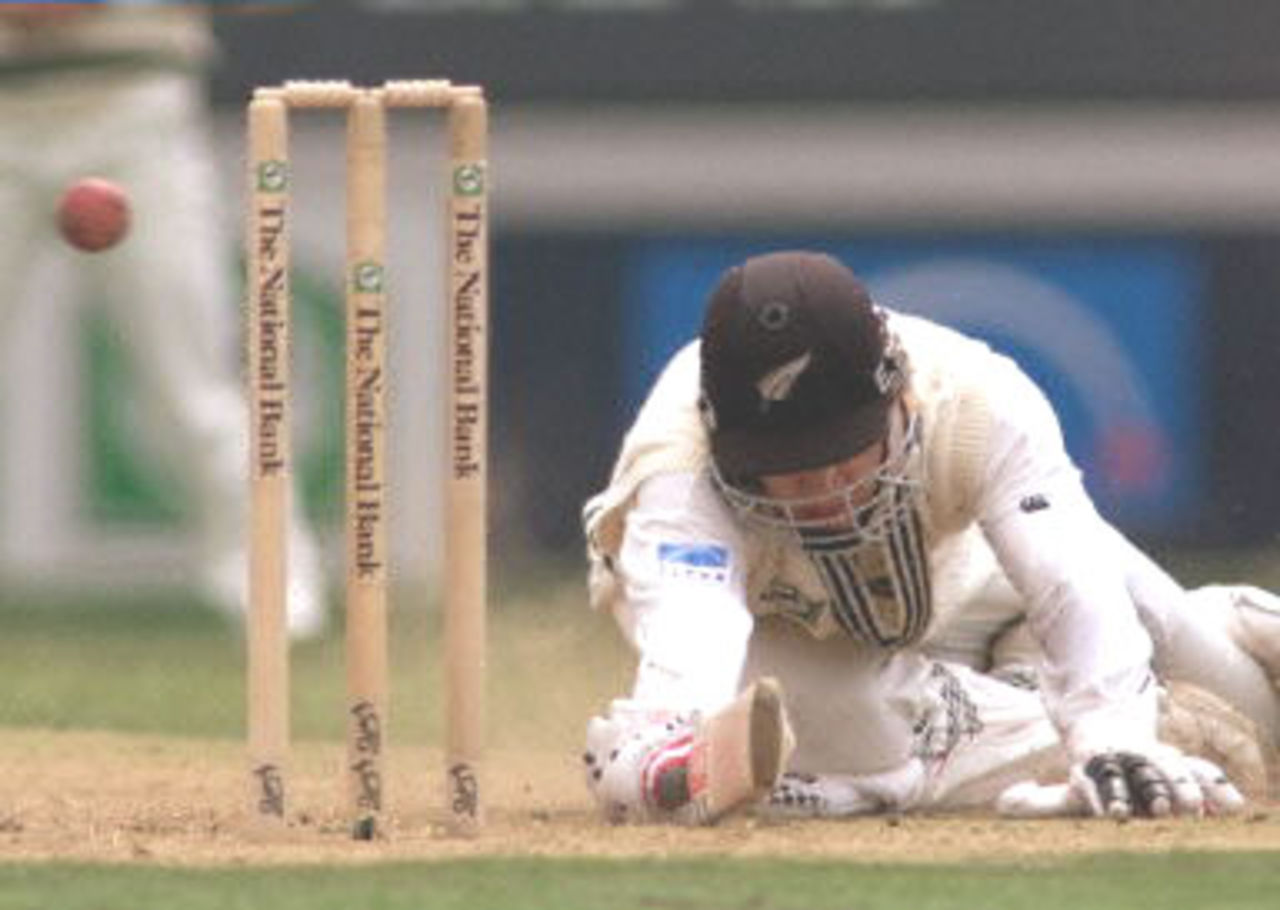 New Zealand batsman Daniel Vettori dives for his ground to beat a throw from an Australian fieldsman on the second day of the first Test Match being played at Eden Park in Auckland. 12 March 2000. Australia was dismissed for 214 in their first innings and dismissed New Zealand for 163 for a 51 run lead.