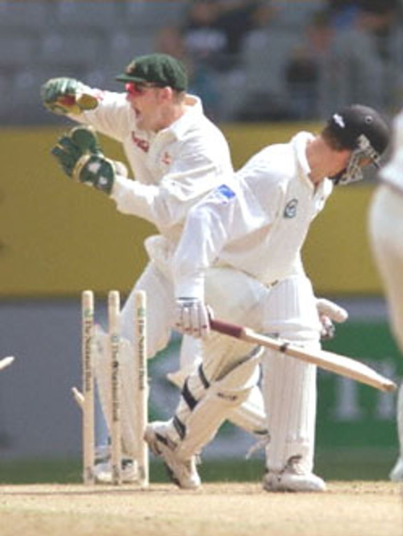Australian wicketkeeper Adam Gilchrist (L) whips off the bails and stumps New Zealand batsman Stephen Fleming (R) on the second day of the first Test match being played at Eden Park in Auckland 12 March 2000. Australia was dismissed for 214 in their first innings and in reply New Zealand is 110-7 at lunch.