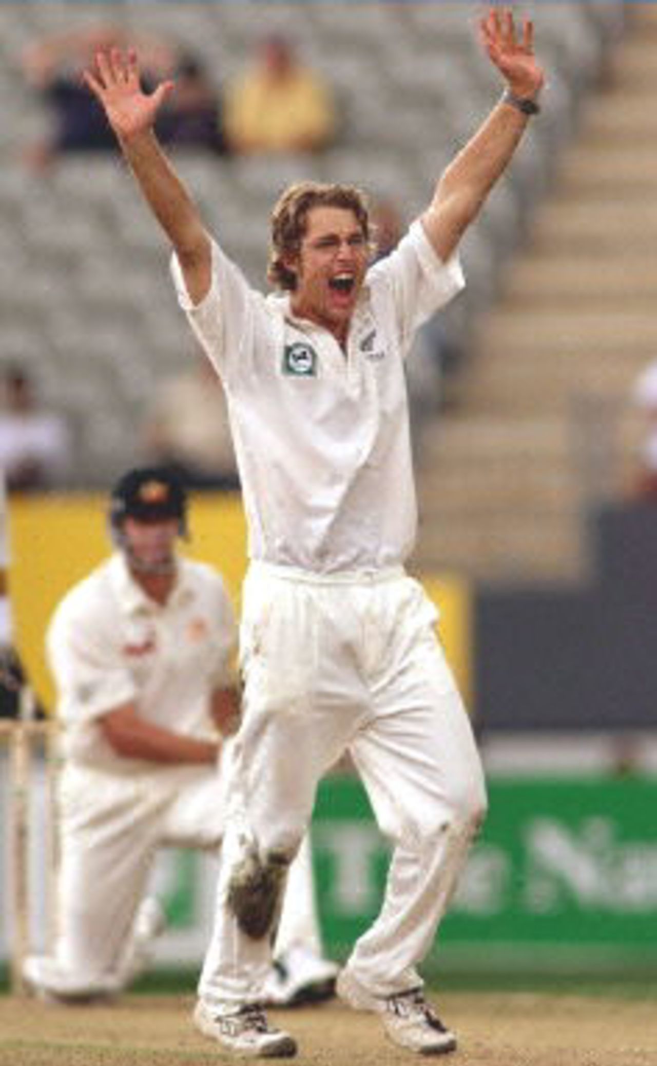 New Zealand spinner Daniel Vettori (R) appeals for an LBW decision against Australian batsman Glenn McGrath (L) on the way to taking 5-62 on the first day of the first Test match being played at Eden Park in Auckland, 11 March 2000. Australia was dismissed for 214 in their first innings and in reply New Zealand is in trouble at 26-4 at stumps.
