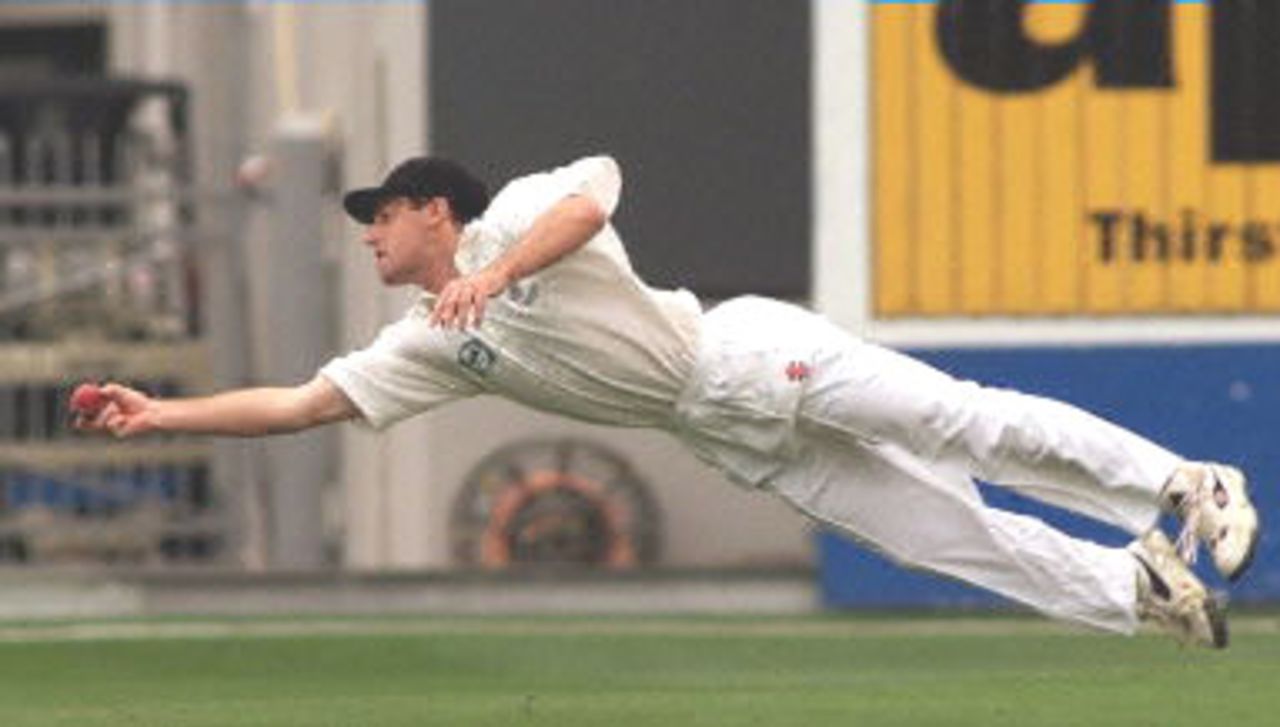 New Zealand fieldsman Craig Spearman dives full length to catch and dismiss Australian captain Steve Waugh for 17 runs off the bowling of Daniel Vettori on the first day of the first Test Match at Eden Park in Auckland 11 March 2000. Australia is 161-6 during the second session.