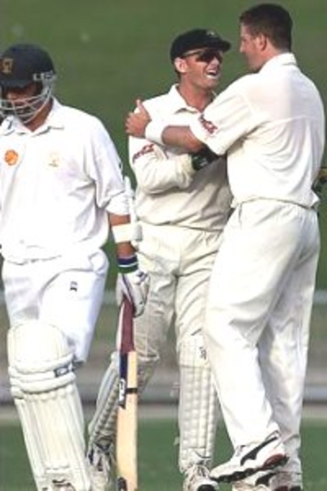 19 Mar 2000: Michael Kasprowicz (right) of Australia celebrates with Adam Gilchrist after dismissing Mathew Sinclair of Central Districts, during day two of the tour game between Central Districts and Australia at McLean Park, Napier, New Zealand.