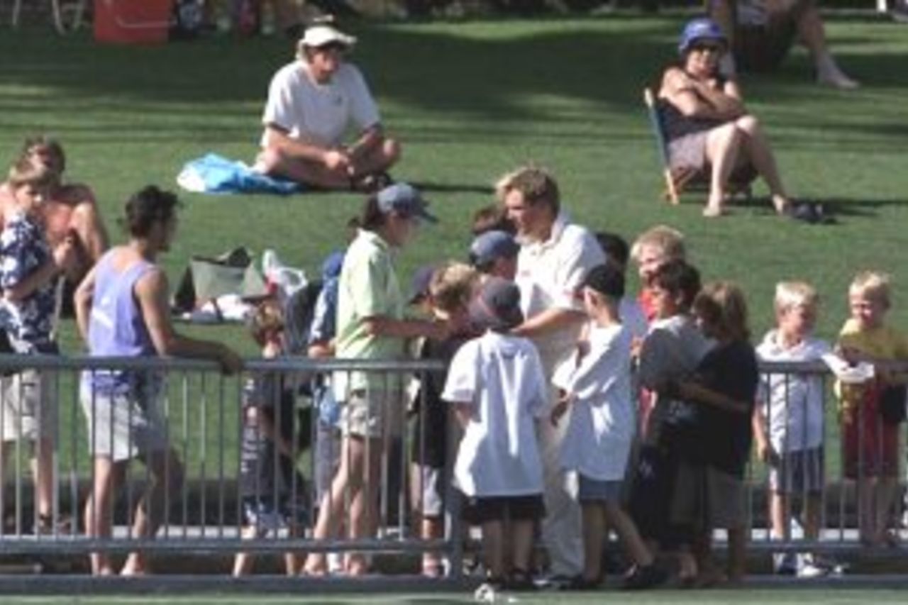 19 Mar 2000: Shane Warne of Australia is surrounded by autograph hunters, during day two of the tour game between Central Districts and Australia at McLean Park, Napier, New Zealand.