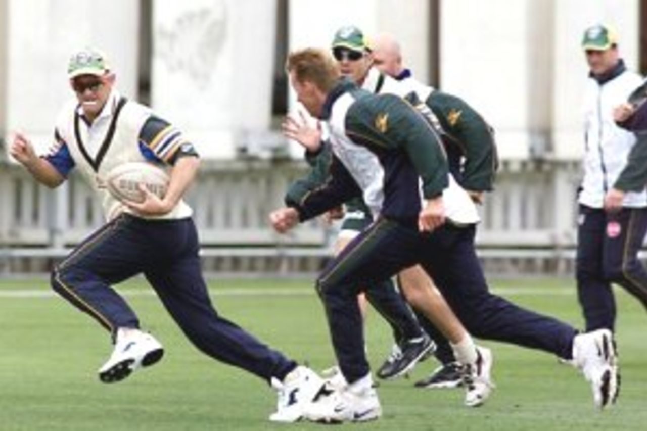 22 Mar 2000: Adam Gilchrist of Australia evades his team mates, during a game of touch rugby, during training at the Basin Reserve, Wellington, New Zealand.