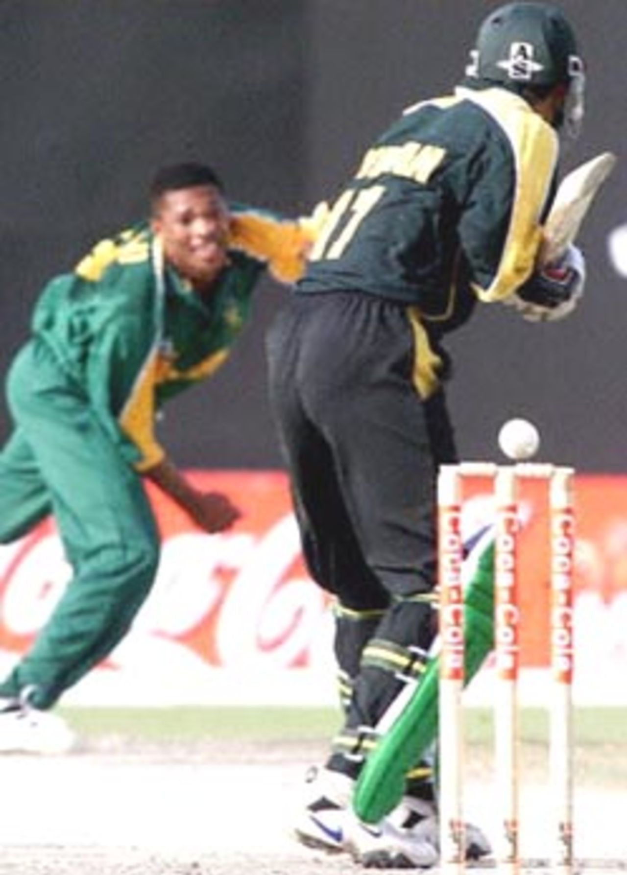 Pakistani batsman Imran Nazir (R) in action against South African bowler Makhaya Ntini during the Champions Cup international at the Sharjah cricket stadium 24 March 2000.