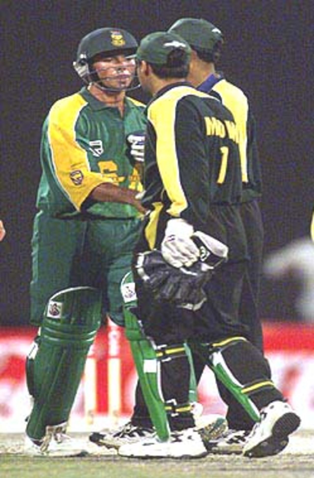 At the end of the match Moin Khan congratulates Nicky Boje, Pakistan v South Africa, Coca-Cola Cup 1999/00, C.A. Stadium Sharjah, 24 March 2000.