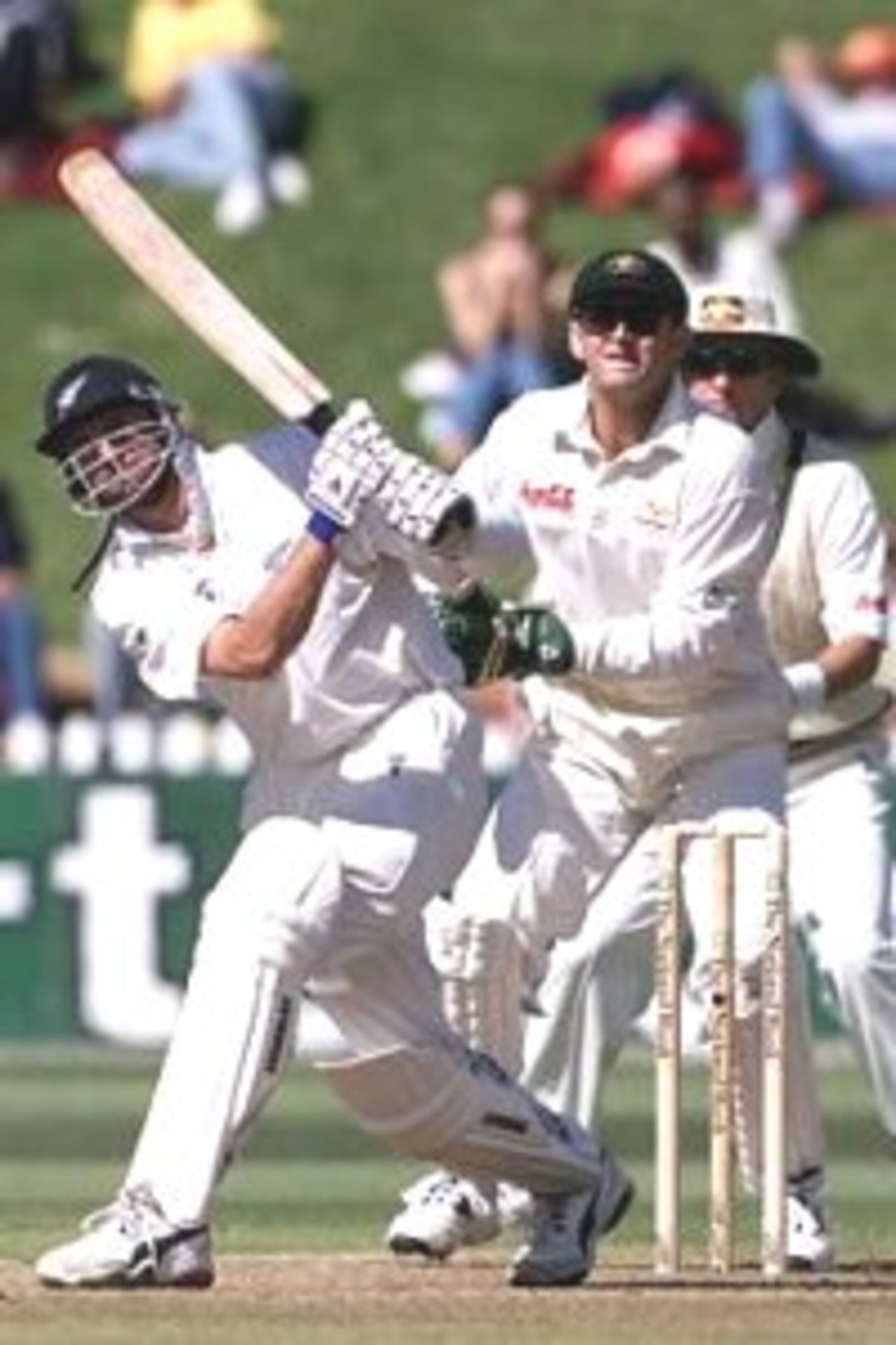 27 Mar 2000: Simon Doull of New Zealand hits out with Adam Gilchrist of Australia looking on, during day four of the second test between New Zealand and Australia at the Basin Reserve, Wellington, New Zealand.
