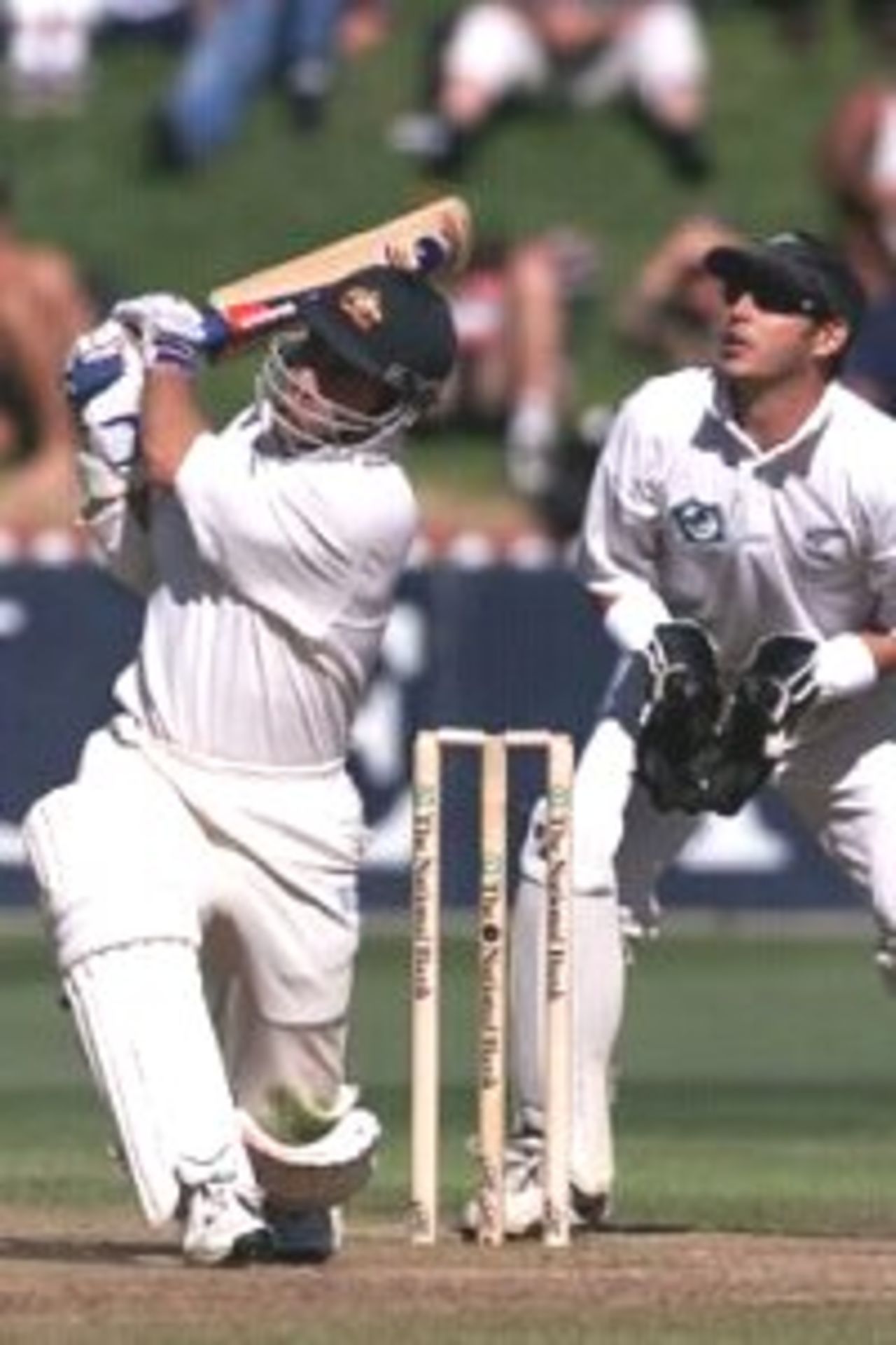 27 Mar 2000: Justin Langer of Australia hits a six with Adam Parore of New Zealand looking on, during day four of the second test between New Zealand and Australia at the Basin Reserve, Wellington, New Zealand.