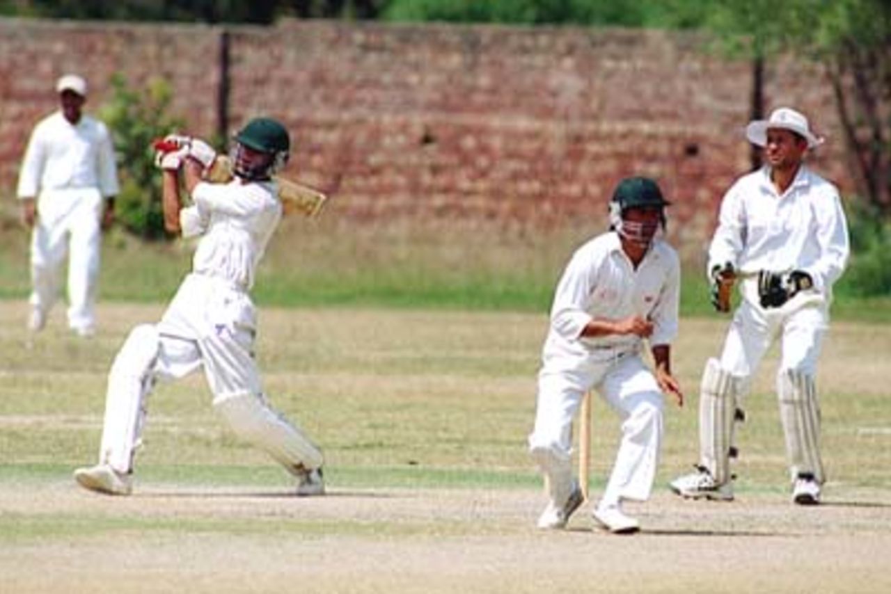 Sily mid-off fielder takes evasive action as Hammad Tariq of Bahawalpur hits a powerful four , LCCA Vs Bahawalpur at LCCA Ground Lahore,27 March 2000.