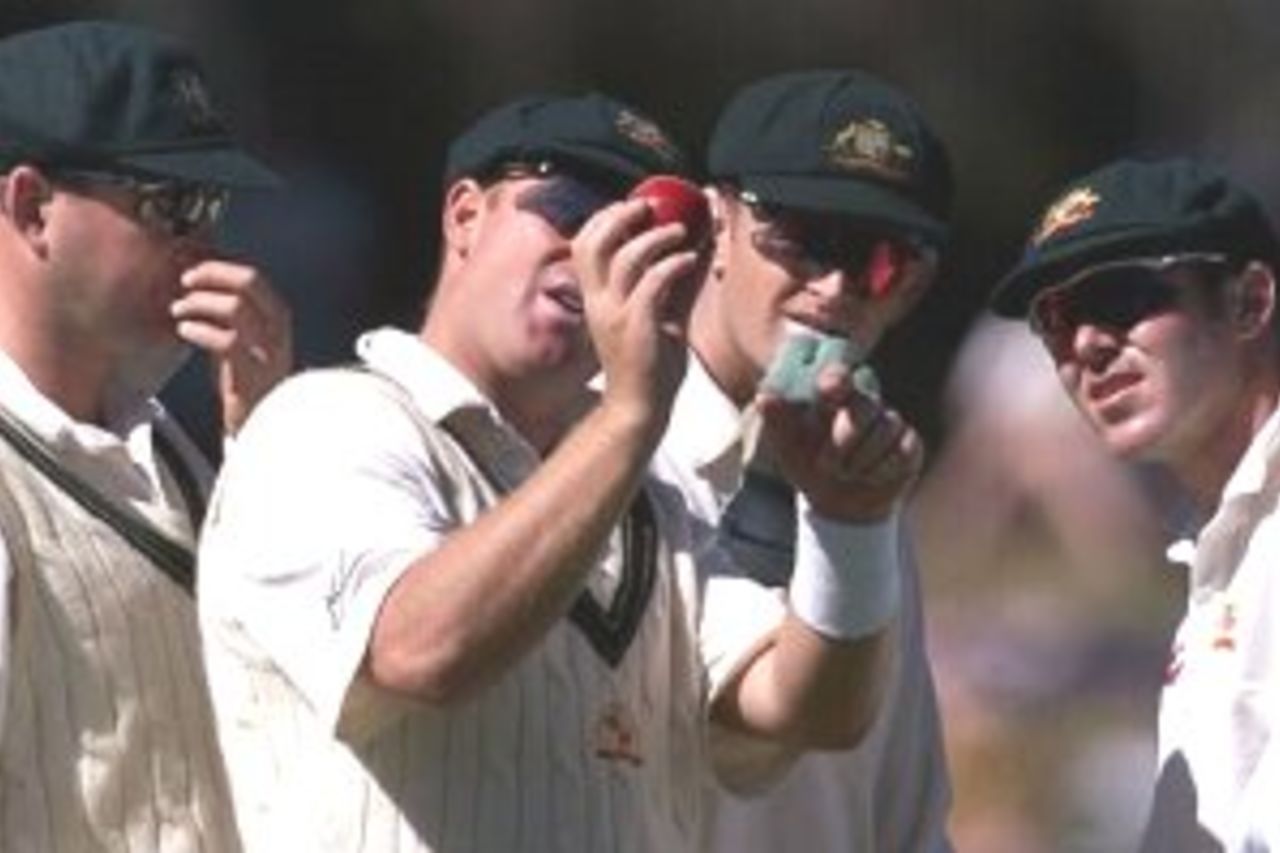 31 Mar 2000: (l-r) Mark Waugh, Shane Warne, Adam Gilchrist and Damien Martyn of Australia, inspect the ball, which needed to be replaced because of faulty stitching, during day one of the third test between New Zealand and Australia, at WestpacTrust Park, Hamilton, New Zealand.