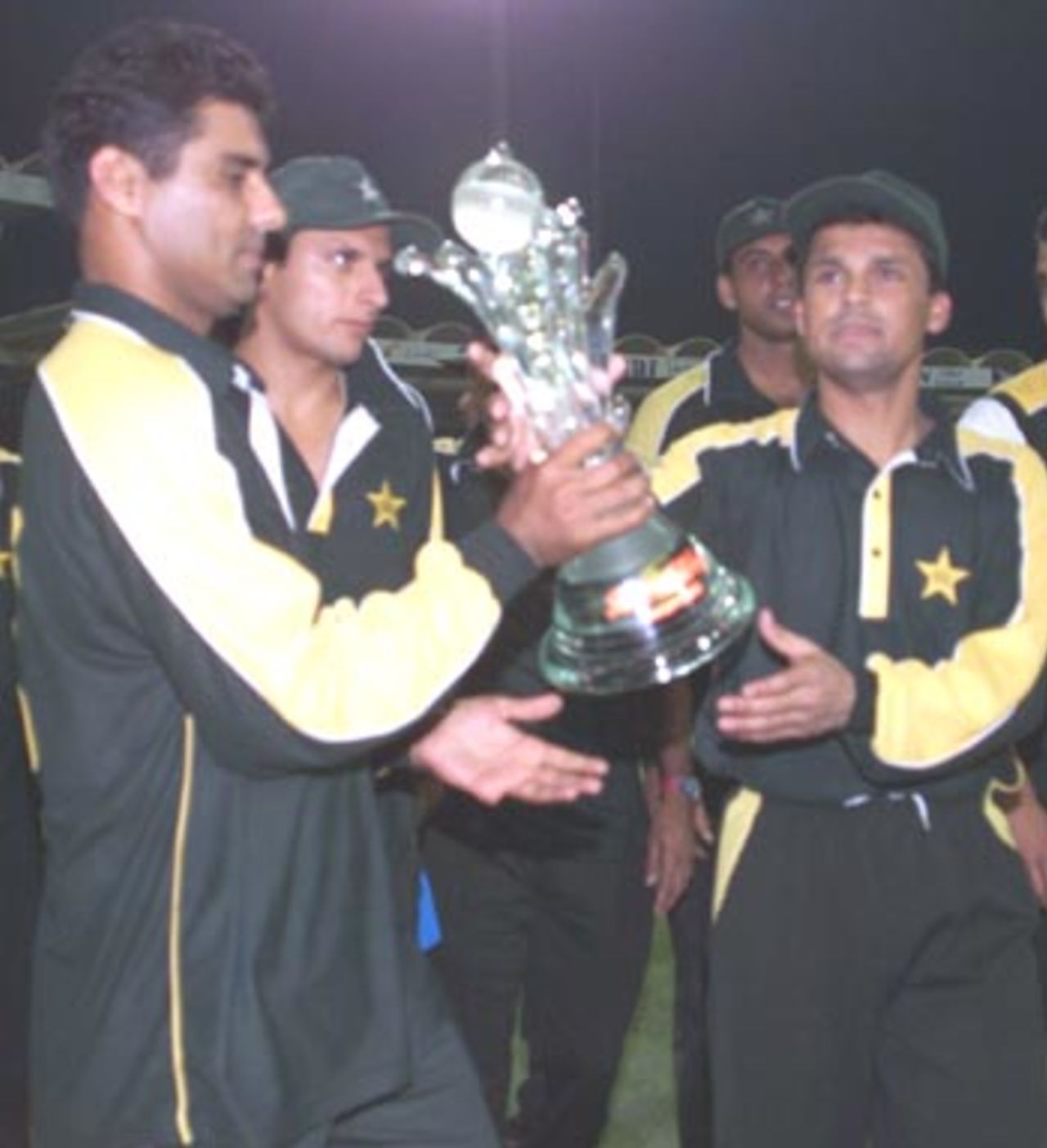 Man of the moment Waqar Younis, victorious captain Moin Khan and Shahid Afridi hold up the Coca Cola Cup 2000, Pakistan v South Africa, Coca-Cola Cup 1999/00, Final, Sharjah C.A. Stadium, 31 March 2000.