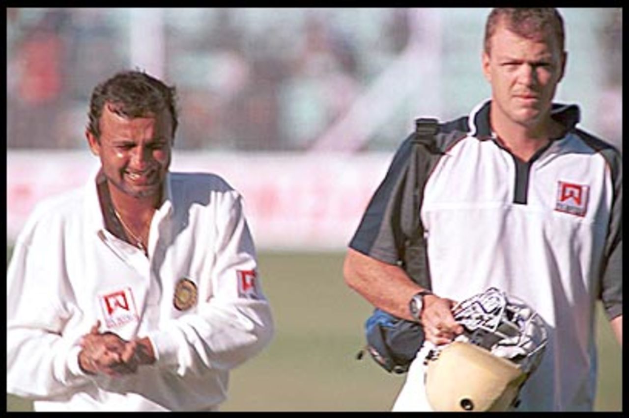 Leipus escorts Mongia off the field. Australia in India 2000/01, 1st Test India v Australia, Wankhede Stadium, Mumbai, 27Feb-03Mar 2001 (Day 2)