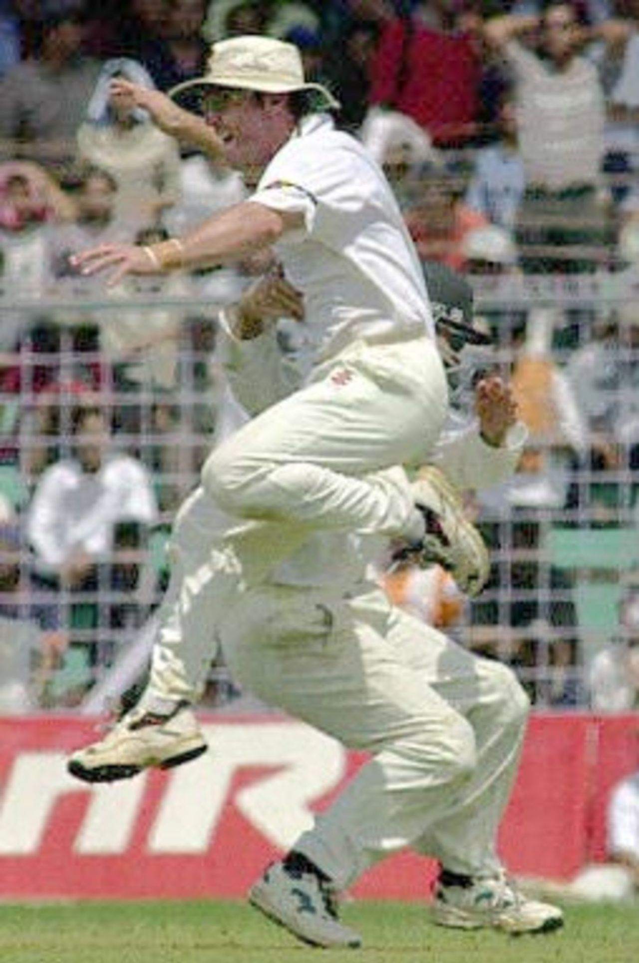 Australian player Michael Slater jumps with joy as the Australian team celebrates after Indian captain Sourav Ganguly was run out from a throw by Slater on the third day of the first test match between India and Australia at the Wankhade Stadium in Mumbai 01 March 2001. Ganguly was out at 1 run as India were in deep trouble at 180 for 6 after conceding a 173 runs lead to Australia in the first innings.
