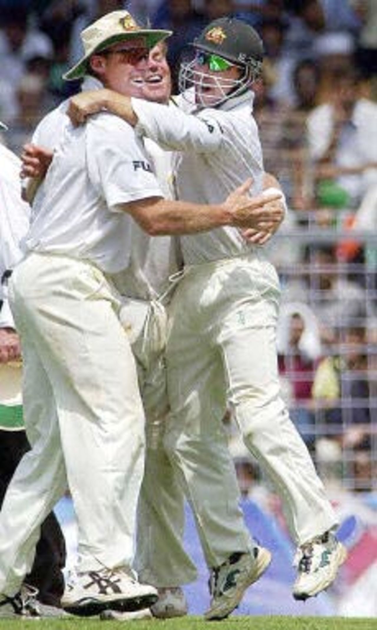 Australian players Glenn McGrath (L), Shane Warne (C), and Justin Langer celebrate the dismissal of Indian captain Sourav Ganguly (not in the picture) during the third day's play of the first Test match between India and Australia at the Wankhede stadium in Mumbai 01 March 2001. India were in deep trouble at 216 for 9 after tea and face an almost certain defeat.
