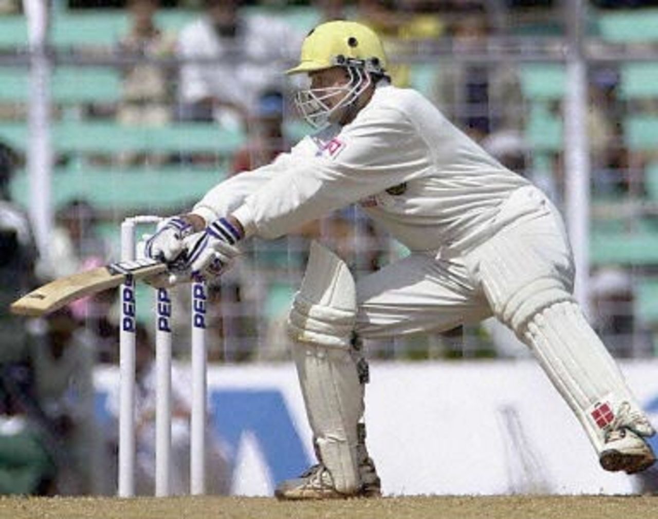 India batsman Nayan Mongia slashes at a delivery from Australian bowler Jason Gillepsie during the third day's play of the first test match between India and Australia at the Wankhade stadium in Mumbai 01 March 2001. Mongia scored a fighting 29 runs however India collapsed at 219 and face an almost certain defeat.
