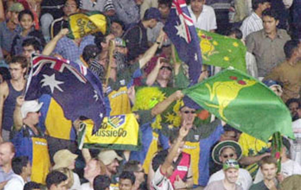 Australian supporters wave their national flags after Australia won the first test match against India on the third day of the first test match between India and Australia at the Wankhade Stadium in Bombay 01 March 2001. Australia beat India by 10 wickets having dismissed India for 219 runs in their second innings.