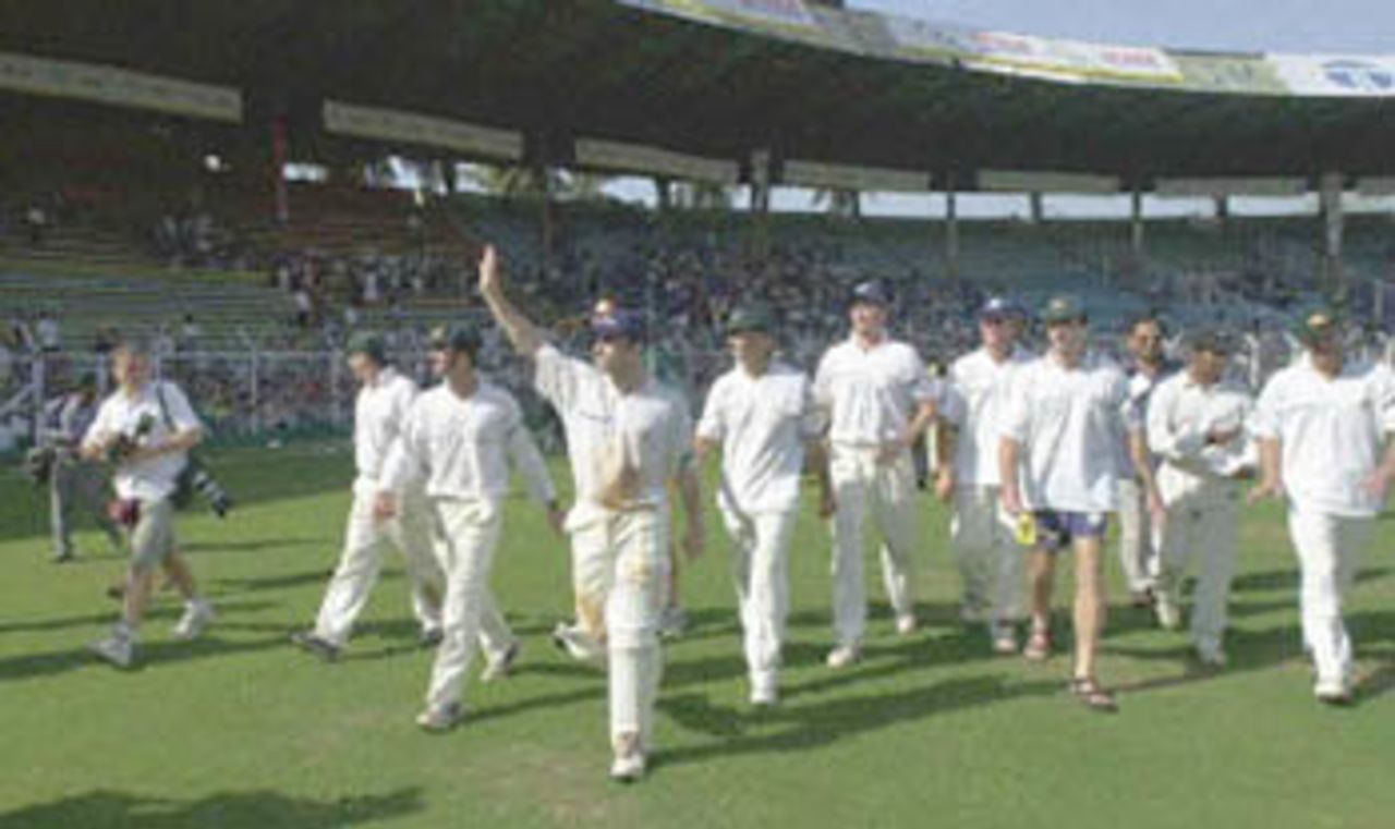 Australian cricket players wave at the cheering crowd while doing a victory lap at the Wankhade Stadium after beating India on the third day of the first test match in Bombay 01 March 2001. Australia won the first of the three test match series by 10 wickets.