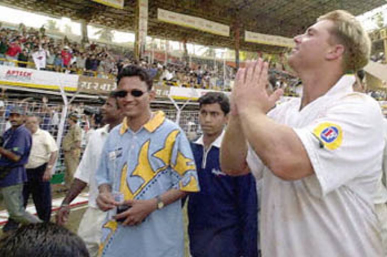 Australian leg spinner Shane Warne (R), popular with the Indian crowds, greets them in a traditional Indian way, amid loud cheering at the end of the first test match between India and Australia at the Wankhade Stadium in Bombay 01 March 2001. Australia beat India by 10 wickets.