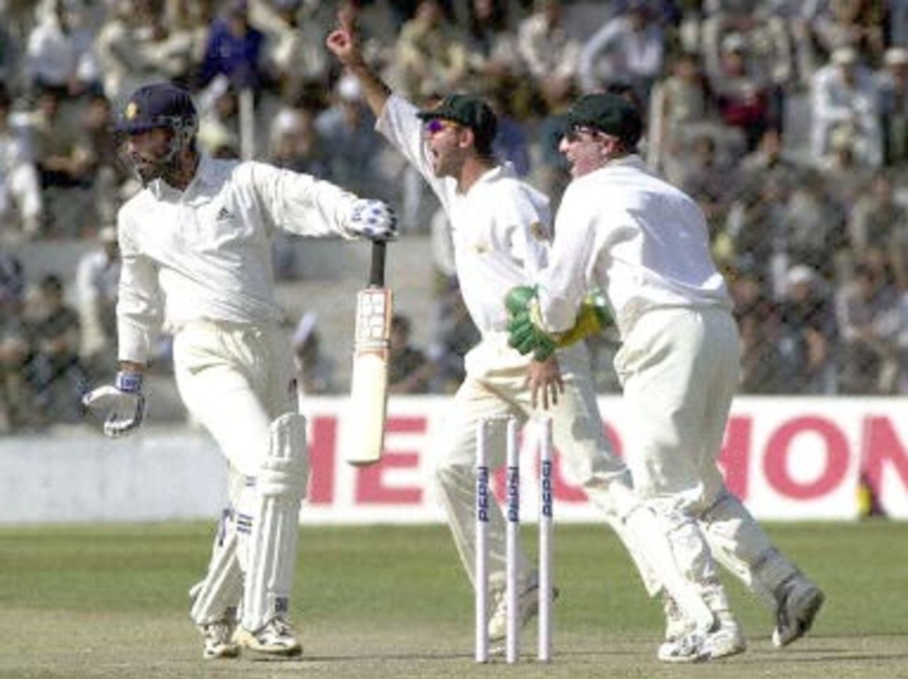 Board President's XI batsman Sarandeep Singh (L) is runout for zero runs as Australian wicketkeeper Brad Haddin (R) and Ricky Ponting (C) celebrate during the second day of their three-day match in New Delhi 07 March 2001. India scored 221 in reply to Australia's 451 in the first innings.