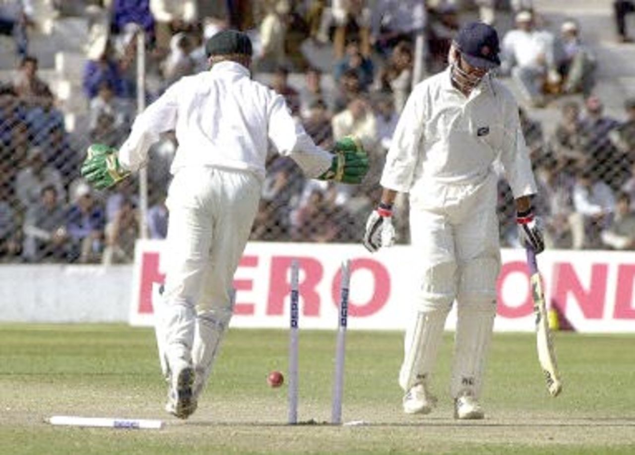 Board President's XI batsman Rakesh Patel (R) is bowled by Australian bowler Colin Miller as wicketkeeper Brad Haddin (L) looks on during the second day of their three-day match in New Delhi 07 March 2001. Australia scored 451 in their first innings with India 221 all out.