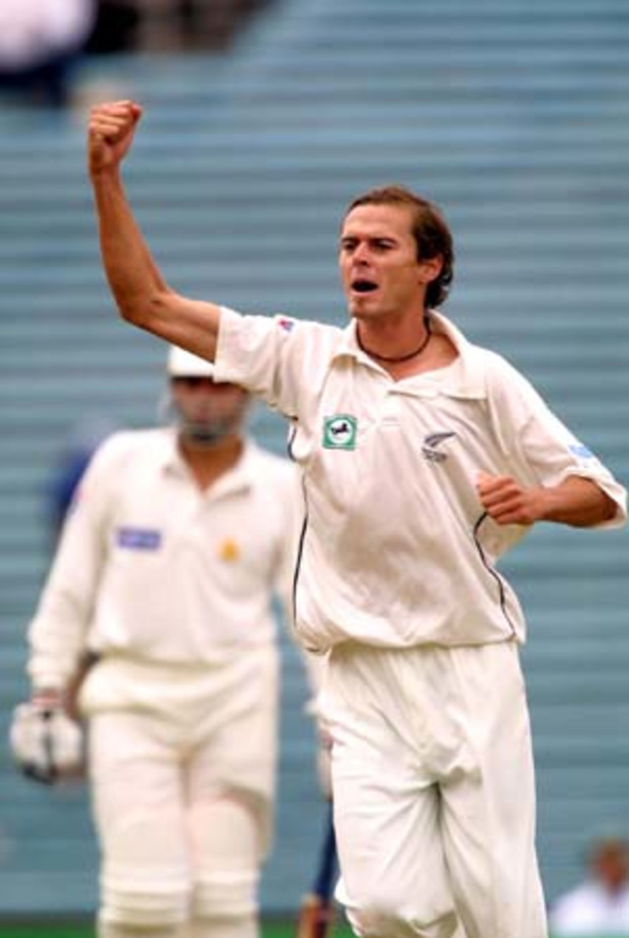 New Zealand fast medium bowler Chris Martin celebrates the dismissal of Pakistan opening batsman Imran Farhat, caught behind by wicket-keeper Adam Parore for 23. Misbah-ul-Haq looks on in the background. 1st Test: New Zealand v Pakistan at Eden Park, Auckland, 8-12 March 2001 (8 March 2001).