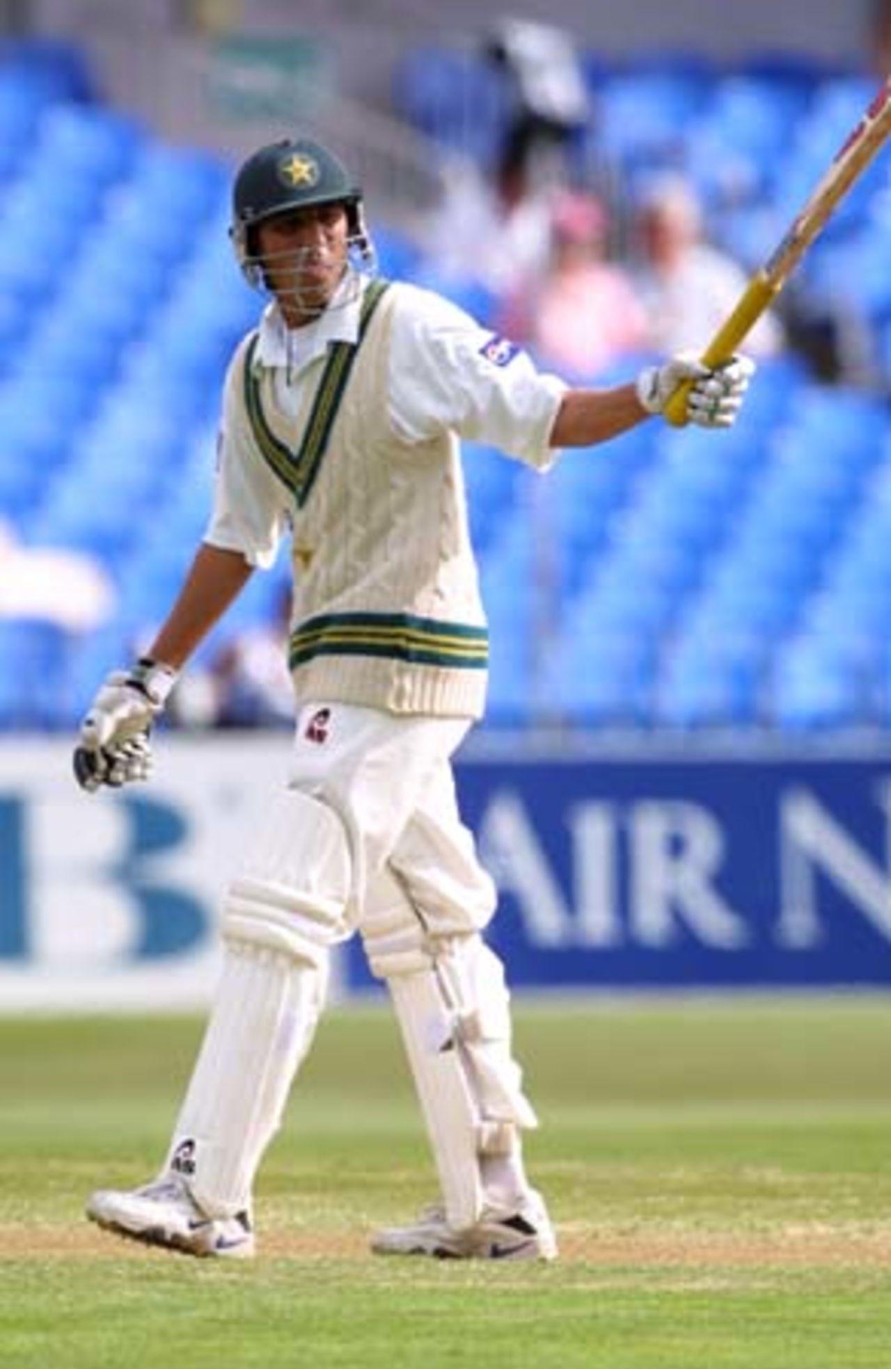Pakistan batsman Younis Khan raises his bat in celebration of reaching his 50. Younis ended the first day's play on 91 not out. 1st Test: New Zealand v Pakistan at Eden Park, Auckland, 8-12 March 2001 (8 March 2001).