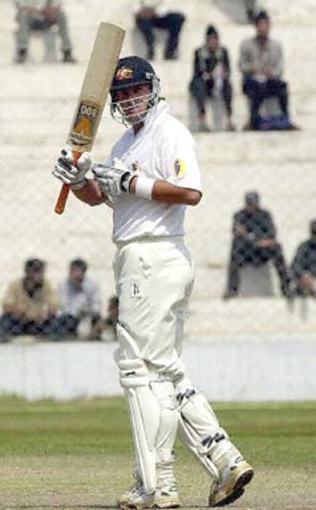 Australian batsman Mark Waugh acknowledges the crowd by raising his bat after scoring a half-century during their second innings against Board President's XI in New Delhi 08 March 2001. Australia scored 451 in their first innings with India at 221.