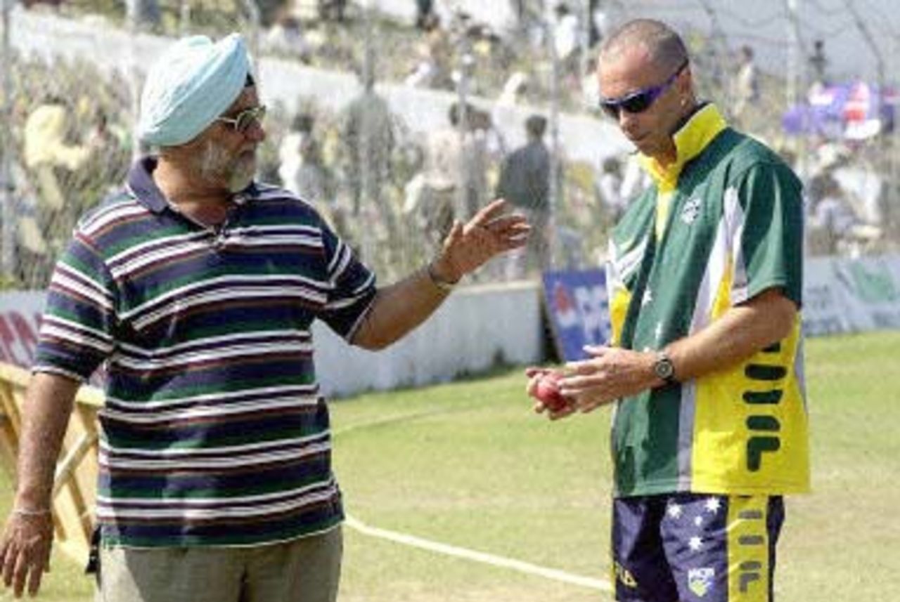 Former Indian Cricket skipper Bishan Singh Bedi (L) gives bowling training to Australian player Colin Miller (R) during their three-day match against Board President's XI at New Delhi's Ferozshah Kotla ground 08 March 2001. Australia scored 461 for seven in their second innings and the match ended in draw.