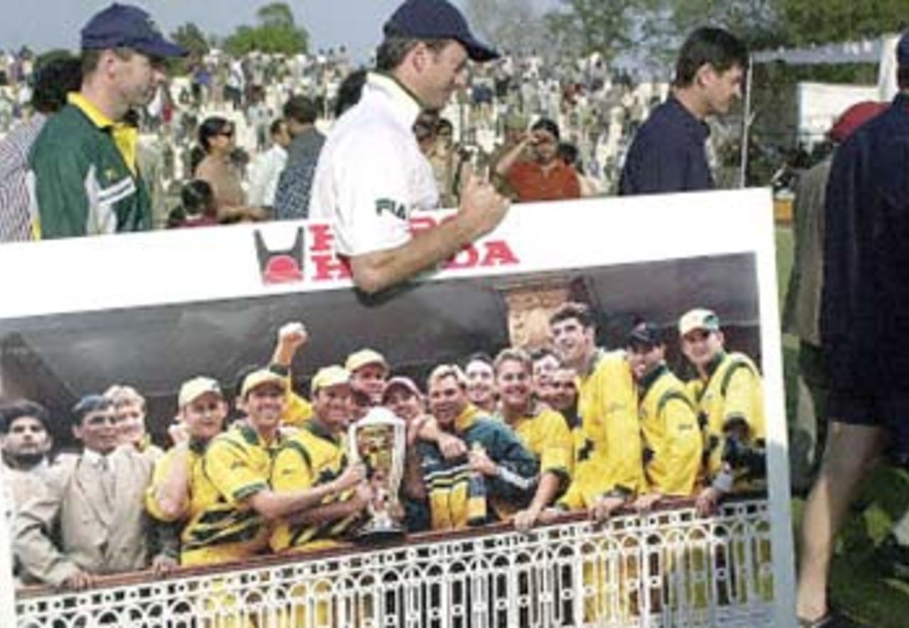 Australian skipper Steve Waugh carries the photograph presented by the Delhi District Cricket Association presented to him after the drawn game against Board President's XI at the Feroz Shah Kotla in New Delhi. 08 Mar 2001 (Day 3)