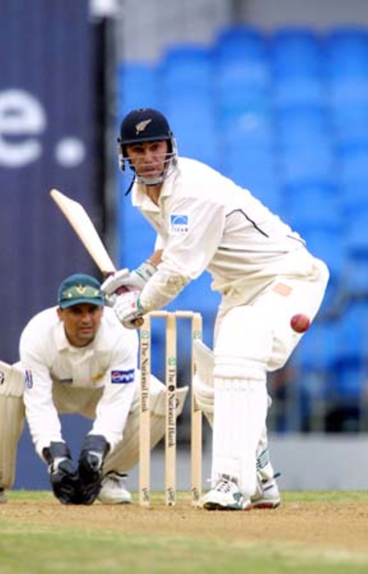 New Zealand batsman Mathew Sinclair shapes to play a delivery from Pakistan off spinner Saqlain Mushtaq while wicket-keeper Moin Khan looks on. Sinclair ended the second day's play on 28 not out. 1st Test: New Zealand v Pakistan at Eden Park, Auckland, 8-12 March 2001 (9 March 2001).