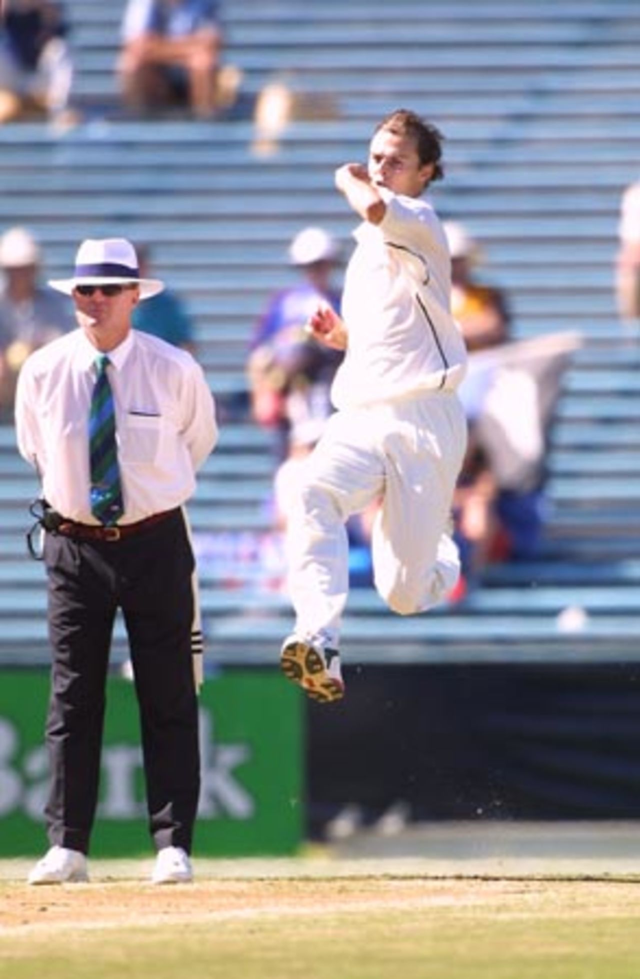 New Zealand fast medium bowler Chris Martin delivers a ball during his second innings spell of 0-65 from 12 overs, while umpire Russell Tiffin looks on. 1st Test: New Zealand v Pakistan at Eden Park, Auckland, 8-12 March 2001 (11 March 2001).