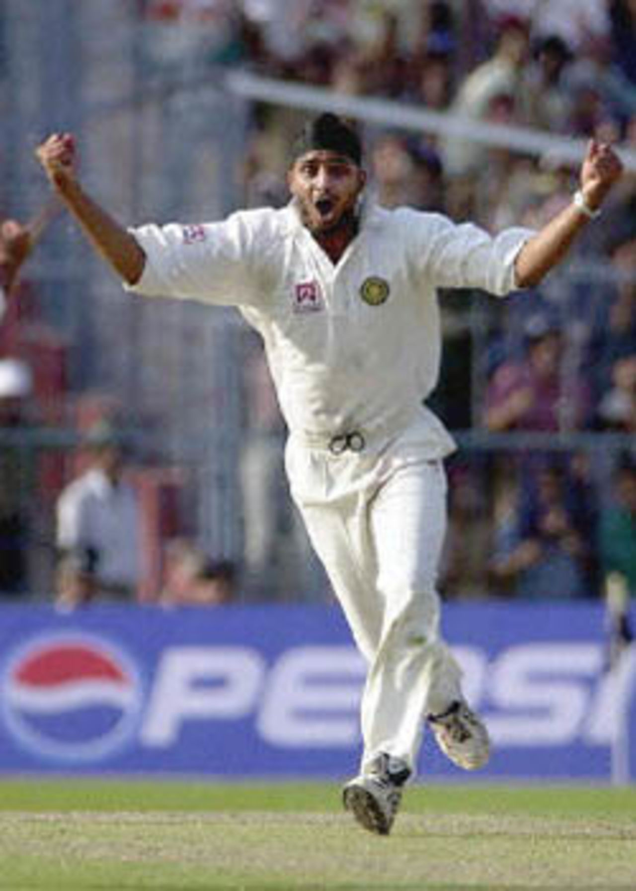 11 March 2001: Indian spinner Harbhjan Singh celebrates after claiming Australian player Shane Warne's wicket to complete a hat-trick on the first day of the second test match between India and Australia at Eden Gardens in Calcutta.
