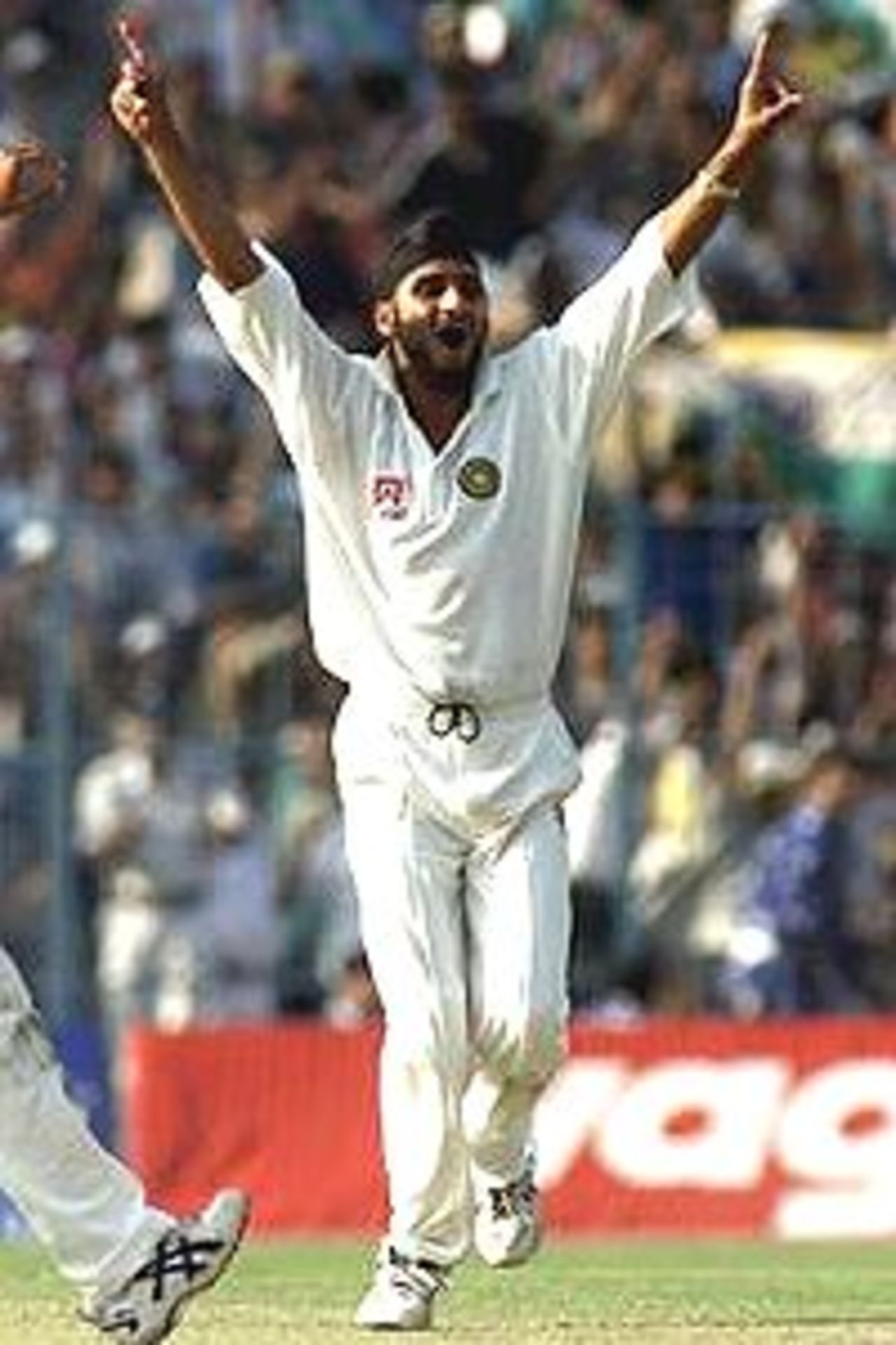 Harbhajan Singh of India claims the wicket of Adam Gilchrist of Australia, the second wicket of a hat trick, during day one of the 2nd Test between India and Australia played at Eden Gardens, Calcutta, India.
