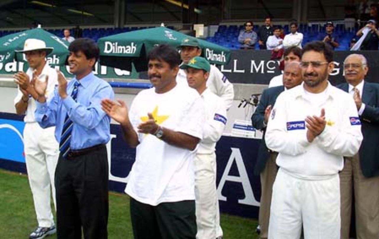 Members of the Pakistan camp celebrate the 299-run victory over New Zealand as the players walk from the field. 1st Test: New Zealand v Pakistan at Eden Park, Auckland, 8-12 March 2001 (12 March 2001).