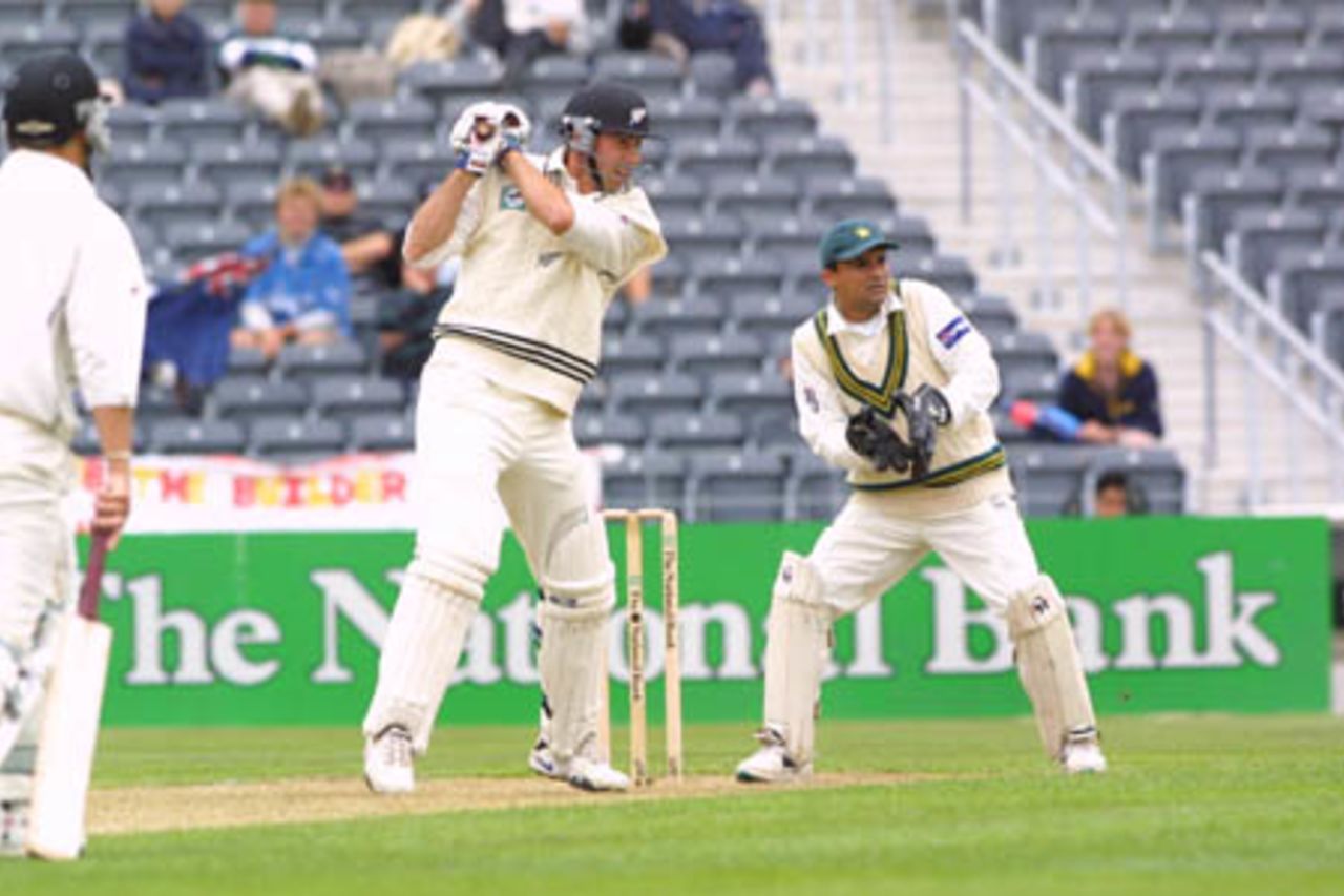 New Zealand batsman Stephen Fleming cuts a ball from Pakistan off spinner Saqlain Mushtaq during his first innings of 32. Batting partner Mathew Sinclair and wicket-keeper Moin Khan look on. 2nd Test: New Zealand v Pakistan at Jade Stadium, Christchurch, 15-19 March 2001 (15 March 2001).