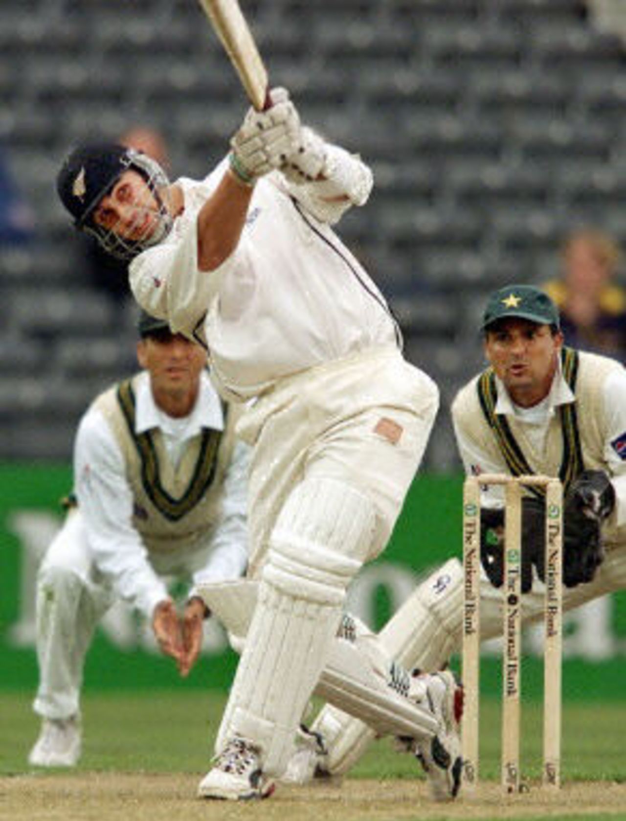 New Zealand batsman Mathew Sinclair lofts a ball for six runs on his way to scoring a century as Pakistan captain Moin Khan and Younis Khan look on on the first day of the second Test Match being played in Christchurch 15 March 2001. New Zealand batting in their first inning was 284-5 at stumps with Sinclair not out on 100.