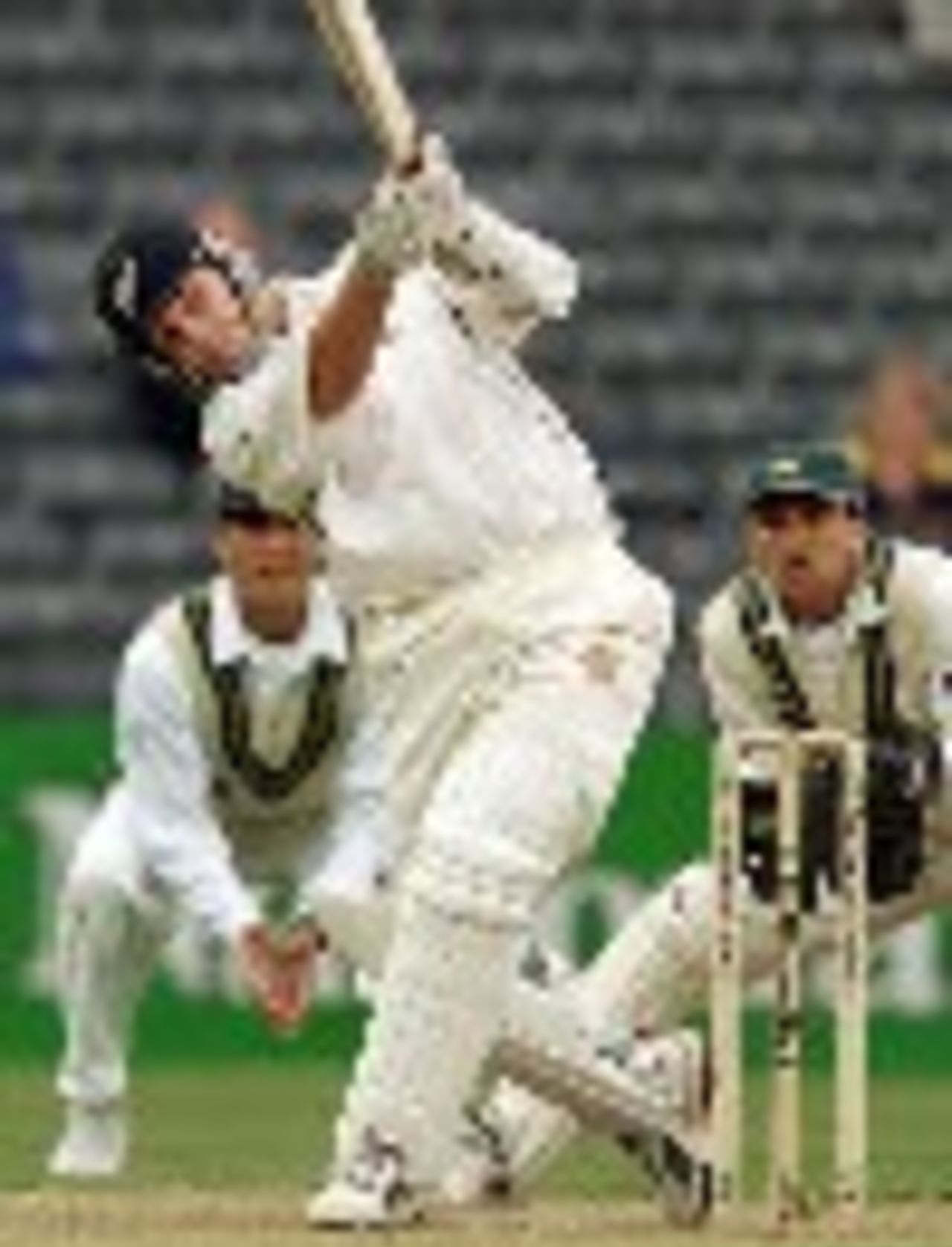 New Zealand batsman Mathew Sinclair lofts a ball for six runs on his way to scoring a century as Pakistan captain Moin Khan and Younis Khan look on on the first day of the second Test Match being played in Christchurch 15 March 2001. New Zealand batting in their first inning was 284-5 at stumps with Sinclair not out on 100.