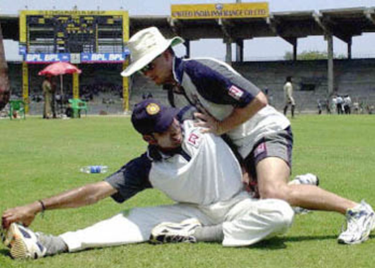 India's top scoring batsman Venkata sai Laxman stretches as physiotherapist Andrew Leipus (R) helps him during a practice session in Chennai, 17 March 2001. India will play the third and final Test match against Australia on March 18.
