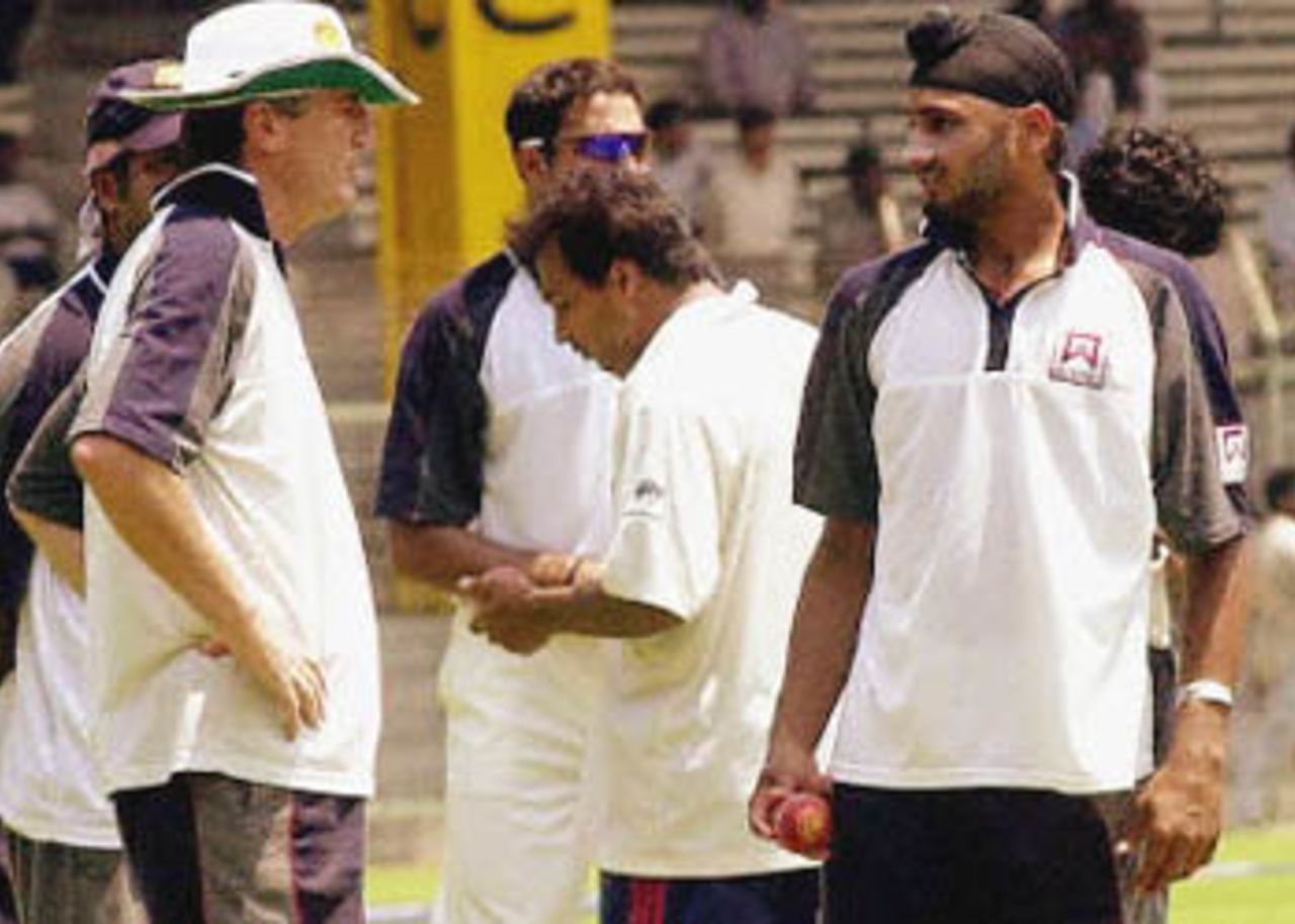 India's coach John Wright (L) speaks to Indian spinner Harbhajan Singh (R) during a practice session in Chennai, 17 March 2001 on the eve of the third and final Test against Australia. Singh took 13 wickets during the second Test match at Eden Gardens in Calcutta.