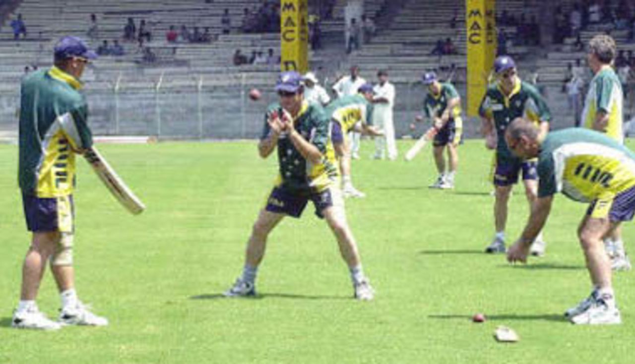 Members of the Australian cricket team warm-up during a practice session in Chennai 17 March 2001. Australia wil play their third and final Test match against Indian on 18 March.