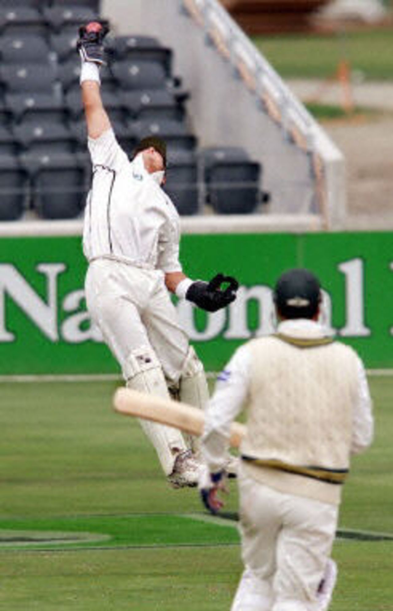 New Zealand wicketkeeper Adam Parore (L) leaps high in the air to catch Pakistan batsman Waqar Younis, day 5, 2nd Test at Christchurch, 15-19 March 2001.
