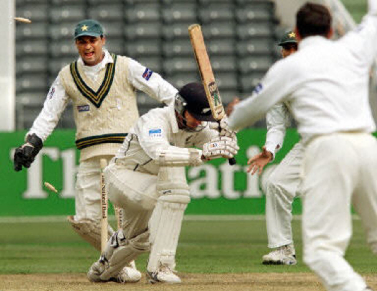 Mark Richardson is clean bowled by Saqlain Mushtaq as Moin Khan and Younis Khan look on, day 1, 2nd Test at Christchurch, 15-19 March 2001.