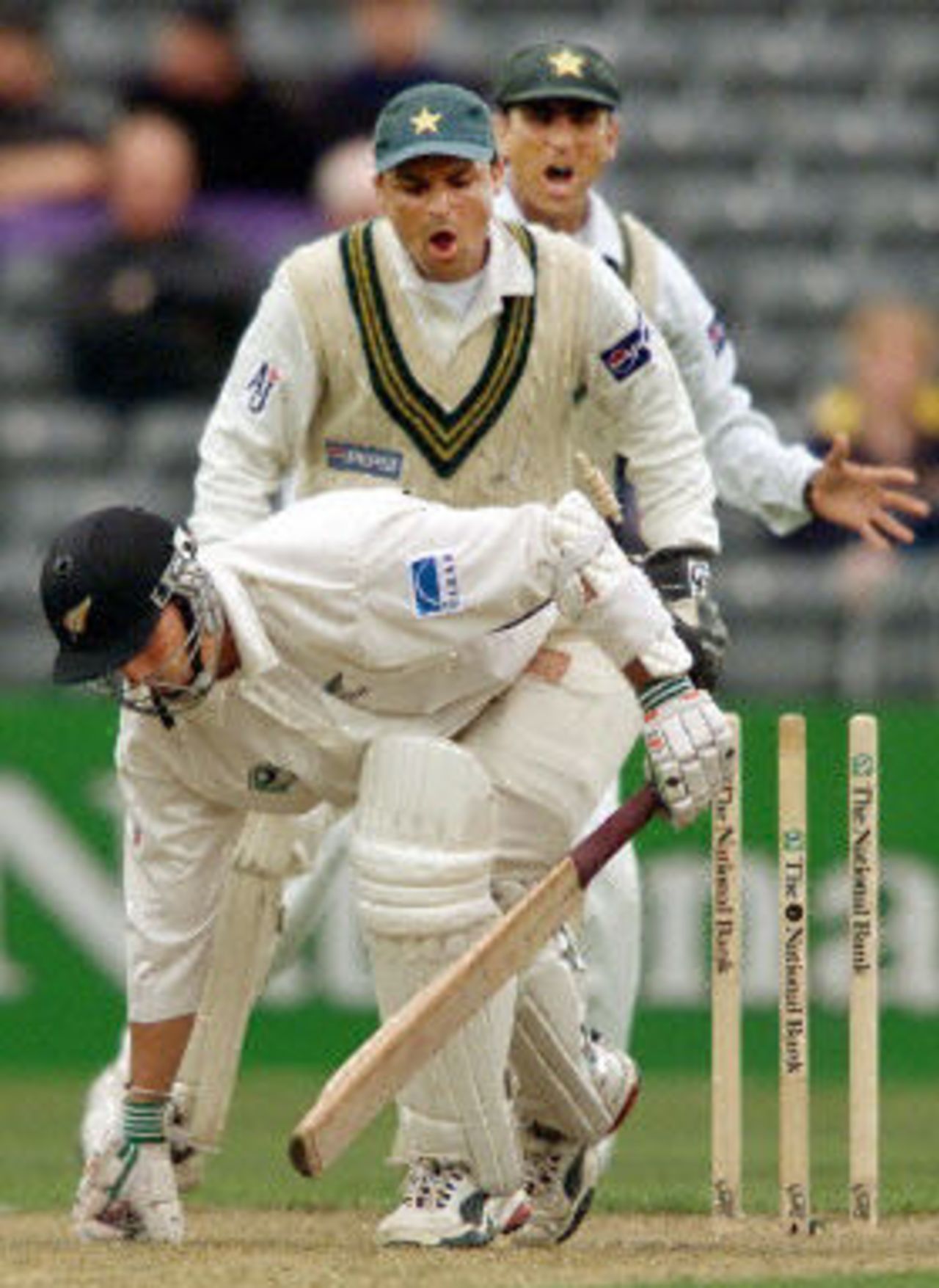 Mathew Sinclair keeps his toe in the crease as Moin Khan attempts a stumping as Younis Khan looks on, day 1, 2nd Test at Christchurch, 15-19 March 2001.
