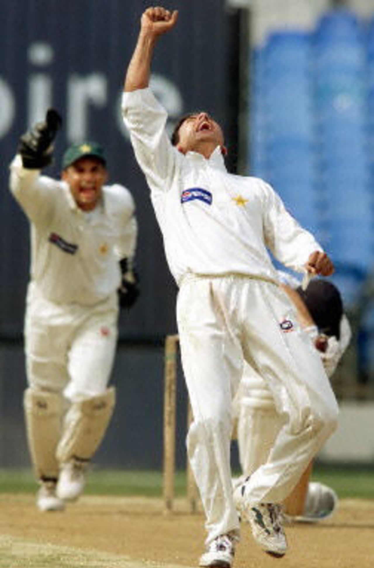 Saqlain Mushtaq celebrates dismissing Stephen Fleming LBW as Moin Khan joins in, day 5, 1st Test at Eden Park in Auckland, 8-12 March 2001.